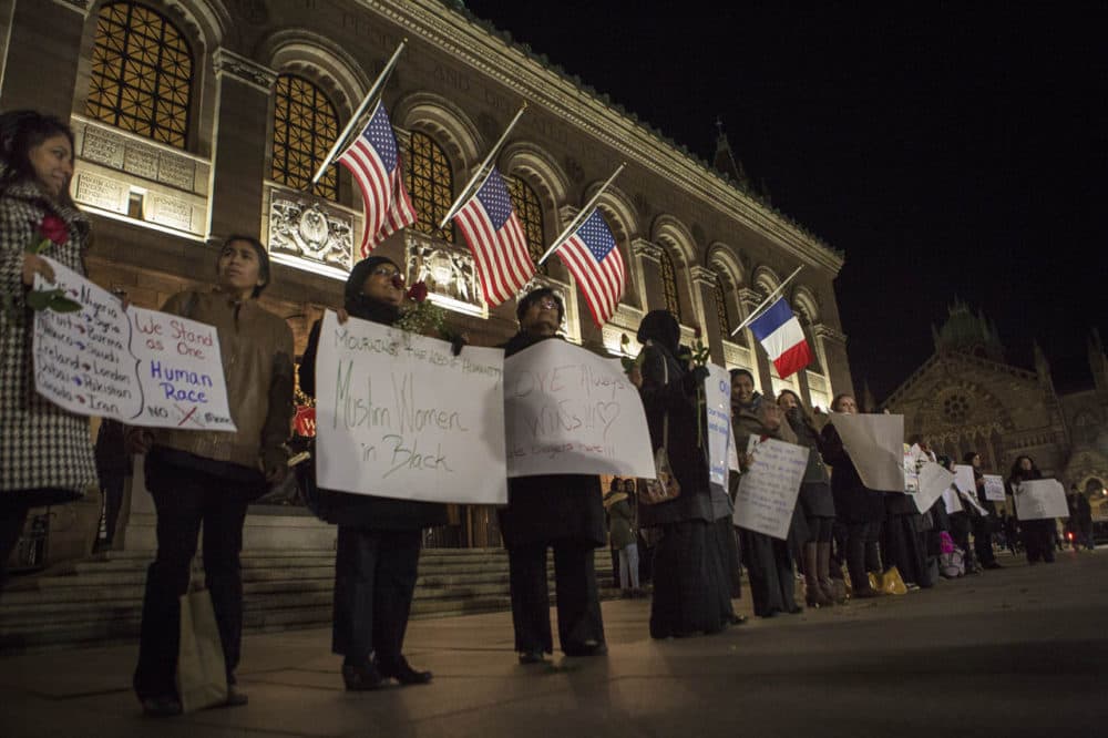 A group of about two dozen Muslim women gathered outside the Boston Public Library in Copley Square to mourn the victims in Paris in what they called a &quot;silent vigil.&quot; (Jesse Costa/WBUR)