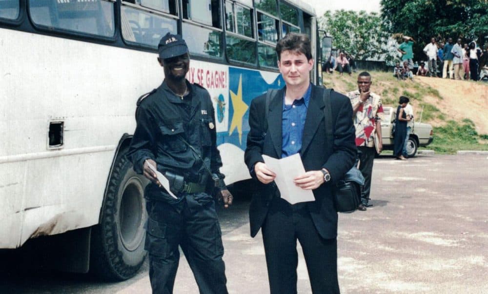 Sasha Chanoff stands next to a hired armed guard in the safe compound outside Kinshasa. (Courtesy)