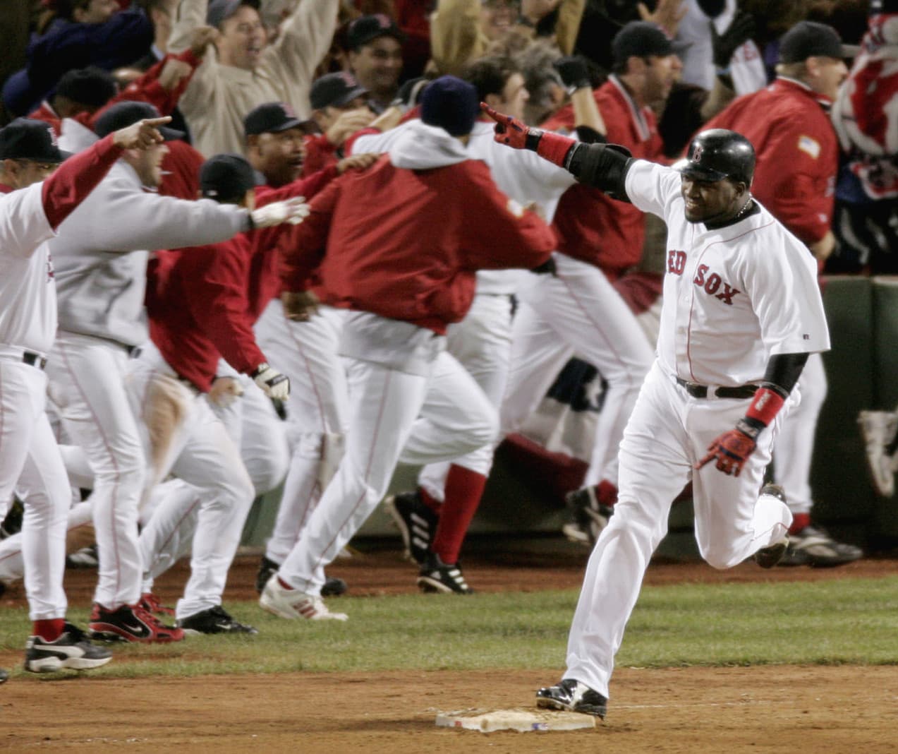 Red Sox's David Ortiz celebrates as he rounds first base after hitting a game-winning home run in the 12th inning of Game 4 of the AL championship series against the Yankees, on Oct. 17, 2004, at Fenway Park. (Amy Sancetta/AP)
