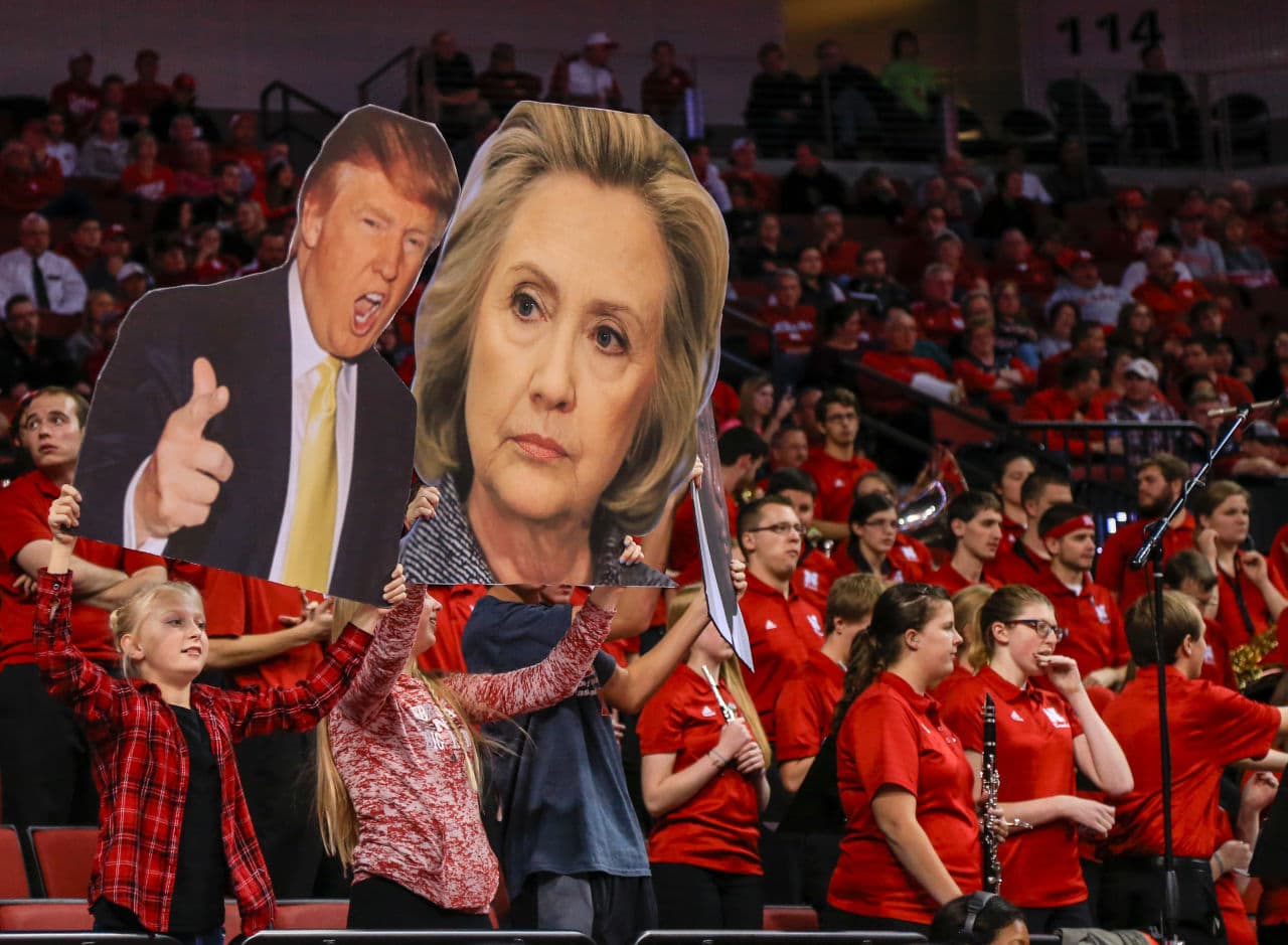 Nebraska fans try to distract Delaware State players with signs of Donald Trump and Hillary Clinton during the second half of an NCAA college basketball game in Lincoln, Neb., Thursday, Nov. 19, 2015. (Nati Harnik/ AP)