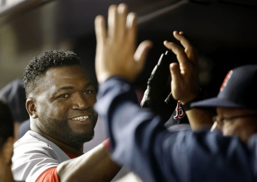 Red Sox's David Ortiz, left, greets teammates in the dugout in September 2015. (Kathy Willens/AP)