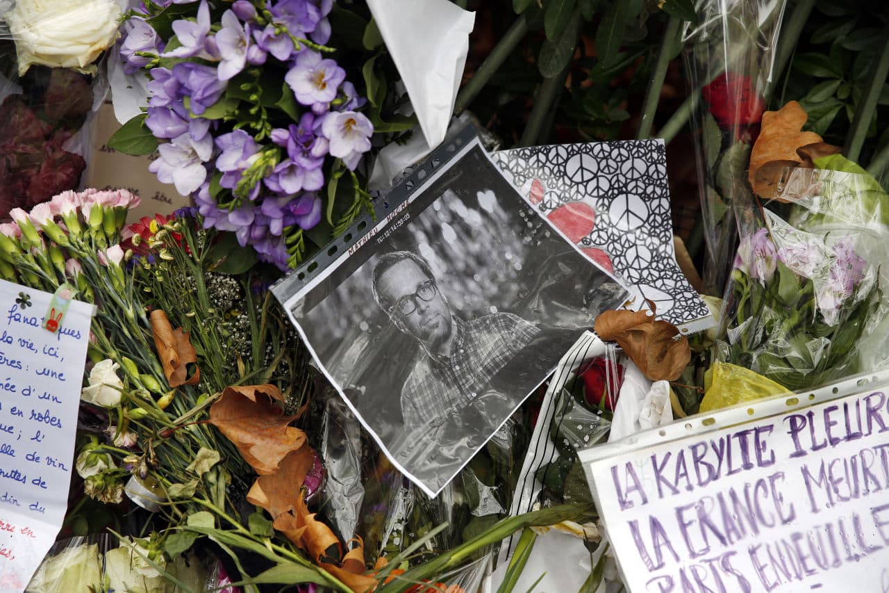 Pictures of victims, flowers and candles are set in memory in front of Le Bataclan concert hall in Paris, France, Tuesday Nov. 17, 2015. Displayed, is a memorial for Mathieu Hoche. (Jerome Delay/AP)