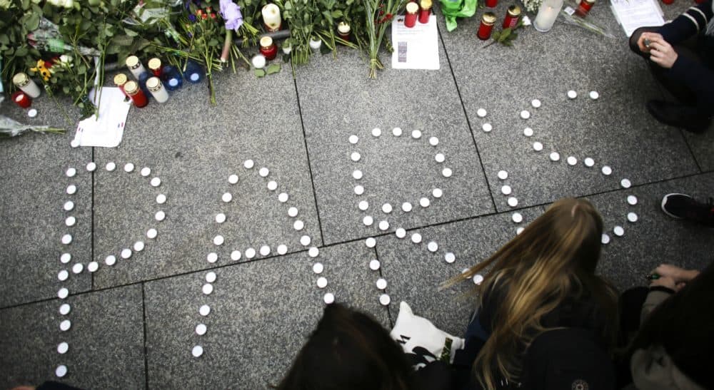 Young women have formed the word Paris with candles to mourn for the victims killed in Friday's attacks in Paris, France, in front of the French Embassy in Berlin, Saturday, Nov. 14, 2015. Multiple attacks across Paris on Friday night have left scores dead and hundreds injured. (Markus Schreiber/ AP)