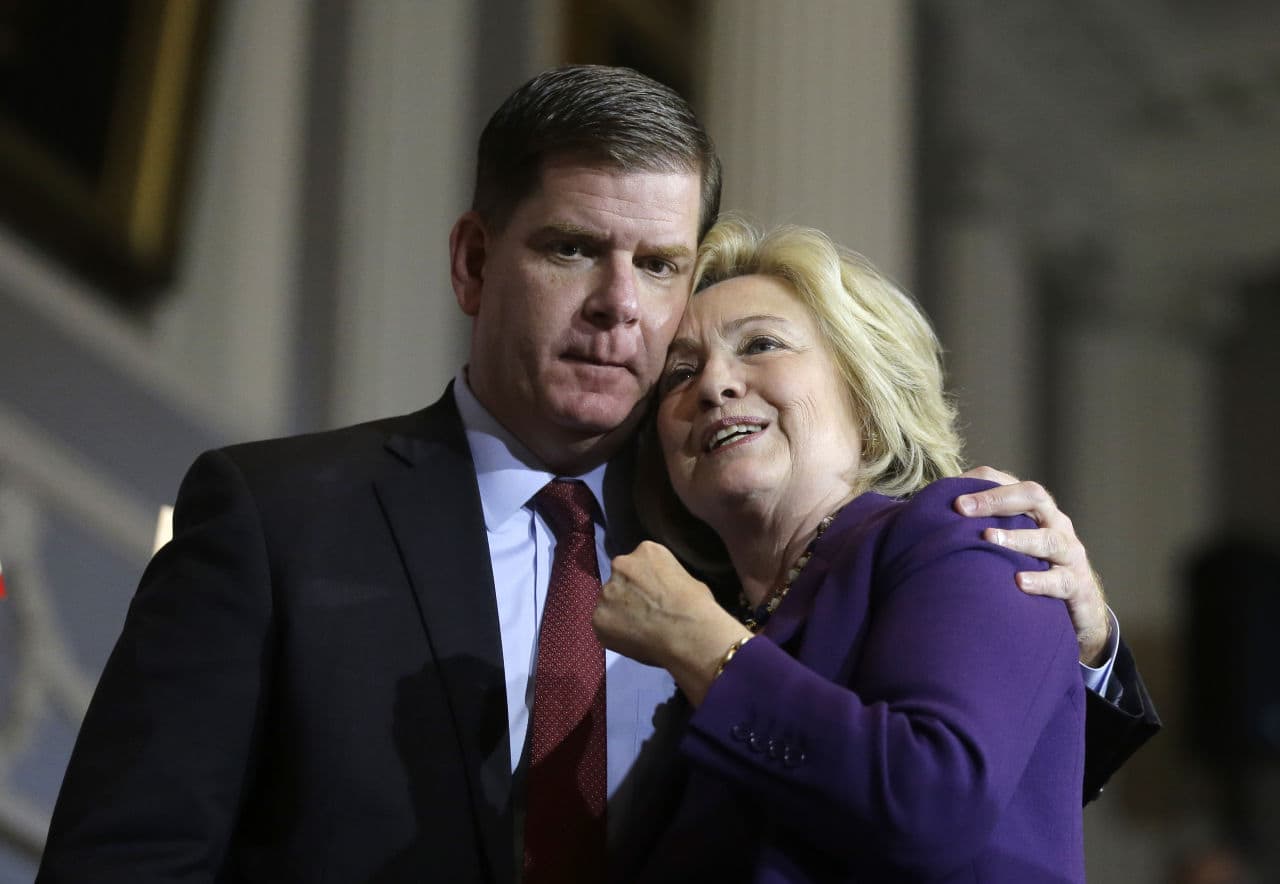 Democratic presidential candidate Hillary Clinton and Boston Mayor Marty Walsh embrace on stage at the conclusion of a rally at Faneuil Hall Sunday. (Steven Senne/AP)