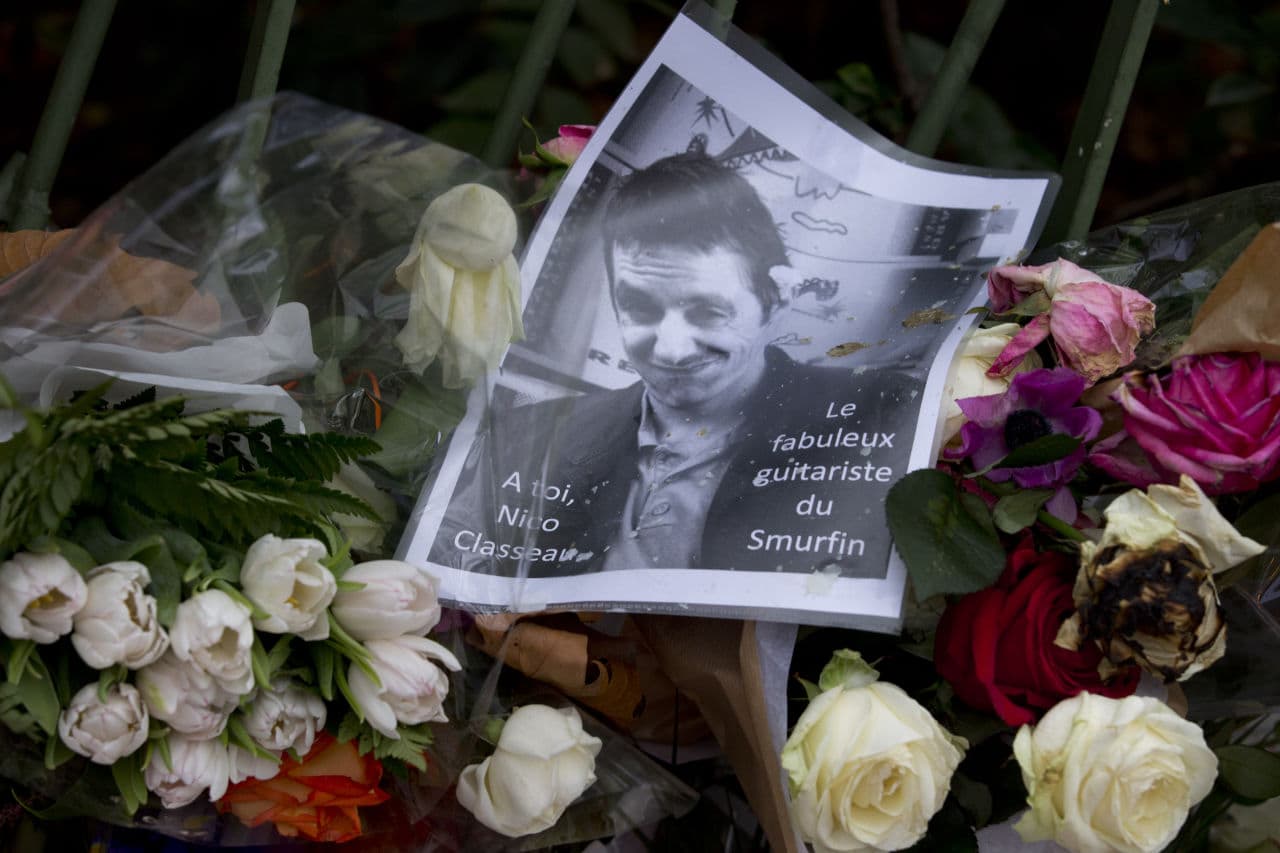 A picture of Nicolas Classeau, teacher and director of the university of Marne-la-Vallee, victim of the attack on the Bataclan concert hall, sits on a memorial outside the Bataclan concert hall in Paris, Tuesday, Nov. 17, 2015. (Peter Dejong/AP)