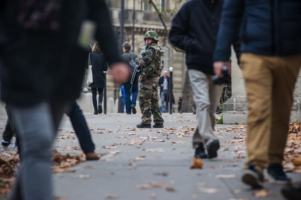 A French soldier patrols outside the French National Assembly in Paris on Saturday. French President Francois Hollande vowed to attack the Islamic State group without mercy as the jihadist group admitted responsibility Saturday for orchestrating the deadliest attacks on France since World War II. (Kamil Zihnioglu/AP)