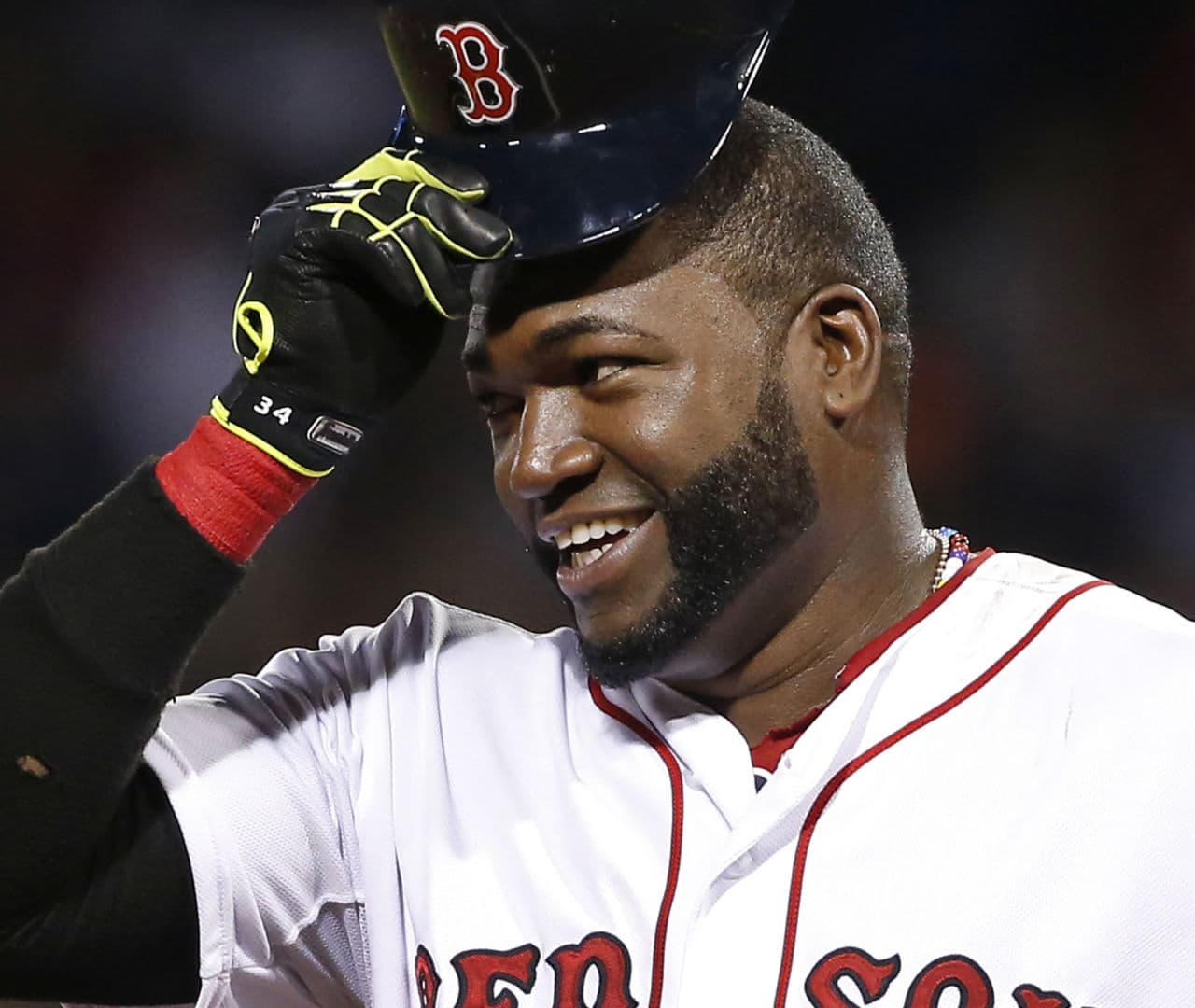 In this Aug. 20, 2014, file photo, Boston Red Sox designated hitter David Ortiz tips his cap while standing on third base during a baseball game against the Los Angeles Angels at Fenway Park in Boston. (Elise Amendola/ AP)