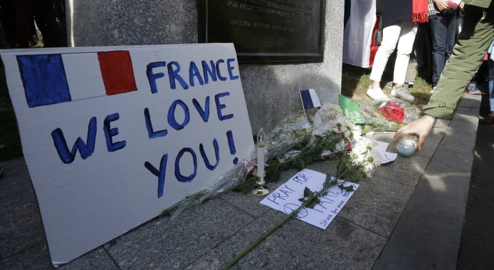 A makeshift memorial for those killed or wounded in the Friday attacks in Paris, as seen at a vigil Sunday, Nov. 15, 2015, in Boston, held in sympathy for the people of Paris. The memorial rests at the foot of a statue of French Revolutionary War military officer Marquis de Lafayette on the Boston Common. (Steven Senne/AP)