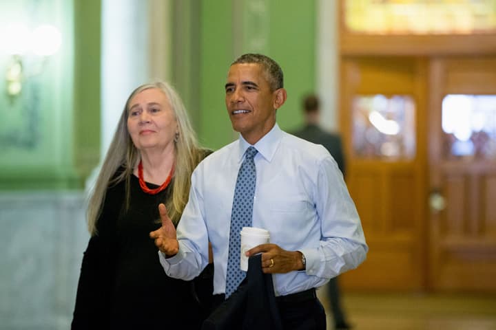 President Barack Obama, accompanied by Pulitzer Prize winning Iowa writer Marilynne Robinson, arrives to the State Library of Iowa in the Ola Babcock Miller Building, Monday, Sept. 14, 2015, in Des Moines. (AP Photo/Andrew Harnik)