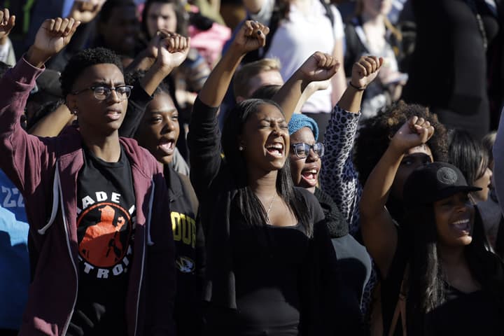 In this Nov. 9, 2015, file photo, students cheer while listening to members of the black student protest group Concerned Student 1950 speak following the announcement that University of Missouri System President Tim Wolfe would resign at the university in Columbia, Mo. (AP)