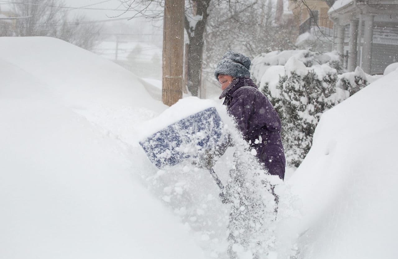Betsy Gaskill shovels the sidewalk by her house in Cambridge. (Robin Lubbock/WBUR)