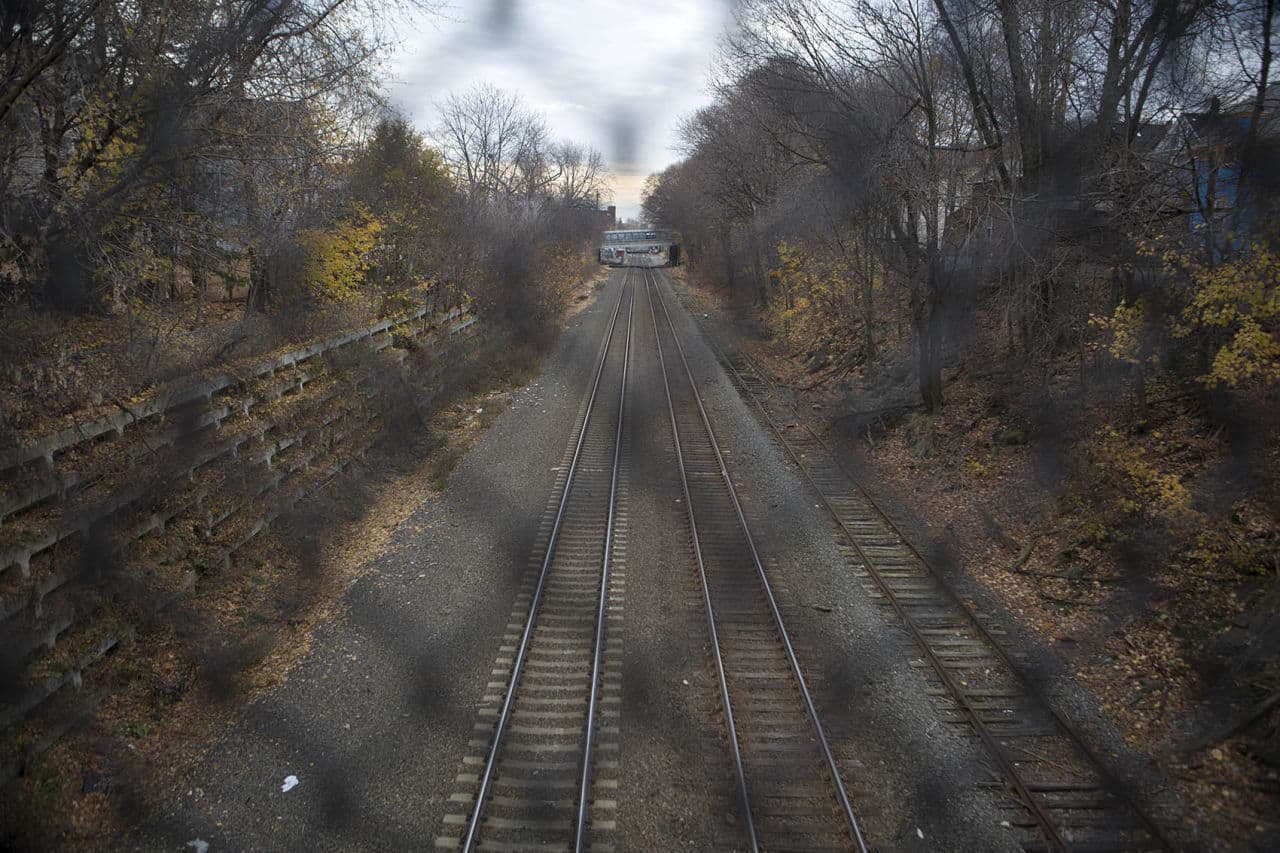 The tracks along the corridor for the proposed Green Line extension to Somerville and Medford already serve commuter rail and Amtrak trains. (Jesse Costa/WBUR)