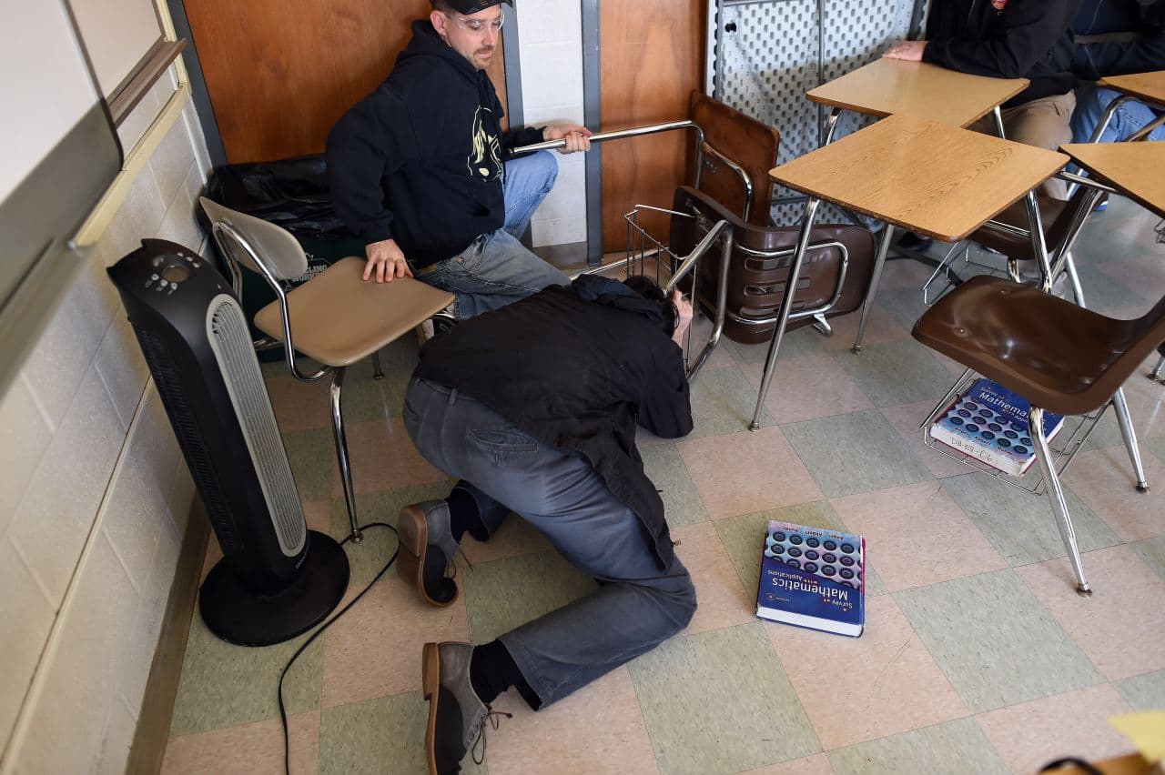 Participants barricade a door of a classroom to block an "active shooter" during ALICE training at the Harry S Truman High School in Levittown, Pennsylvania, on November 3, 2015. (Jewel Samad/AFP/Getty Images)