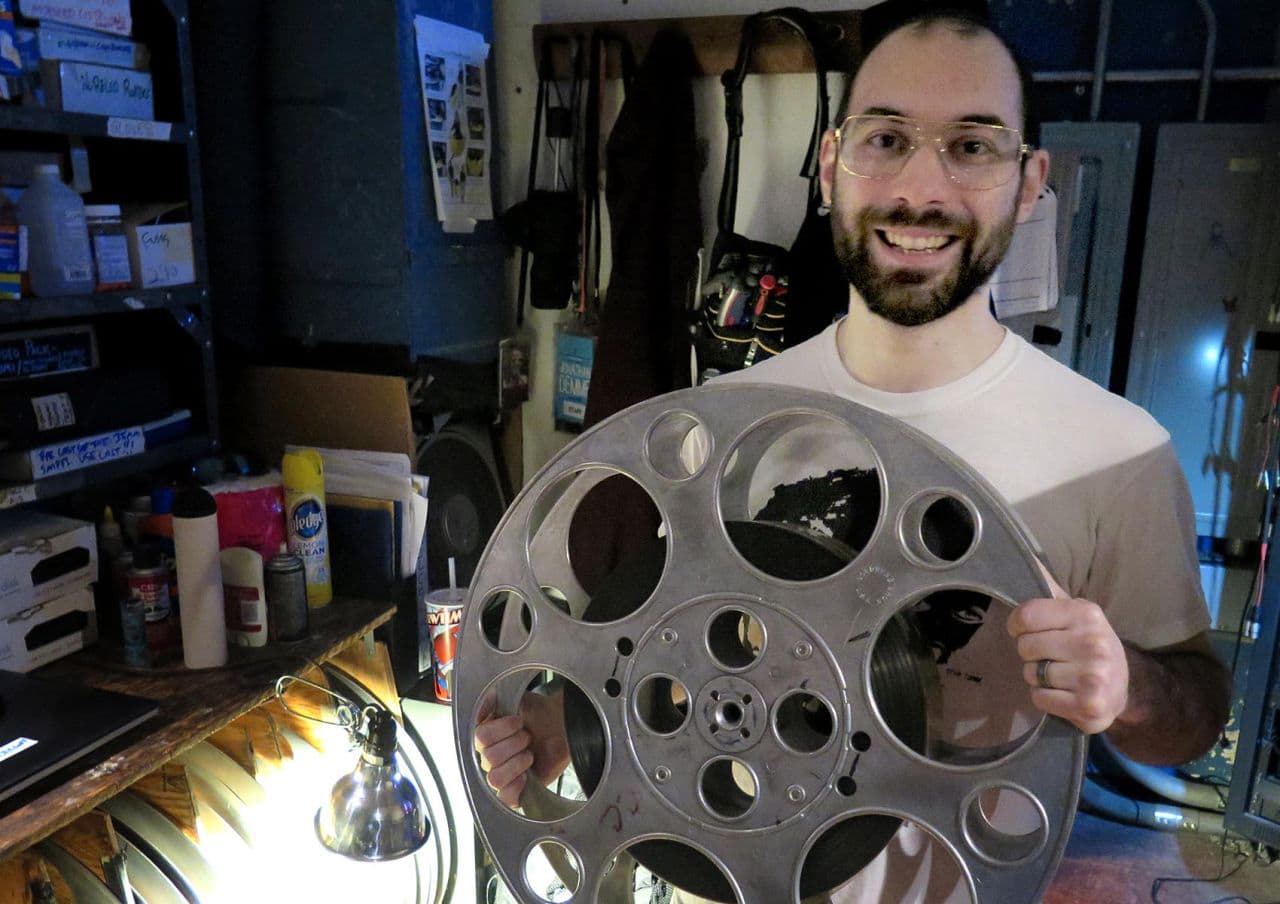 NIck Lazzarro, head projectionist at the Coolidge Corner Theatre, holds a 70 mm spool. (Andrea Shea/WBUR)
