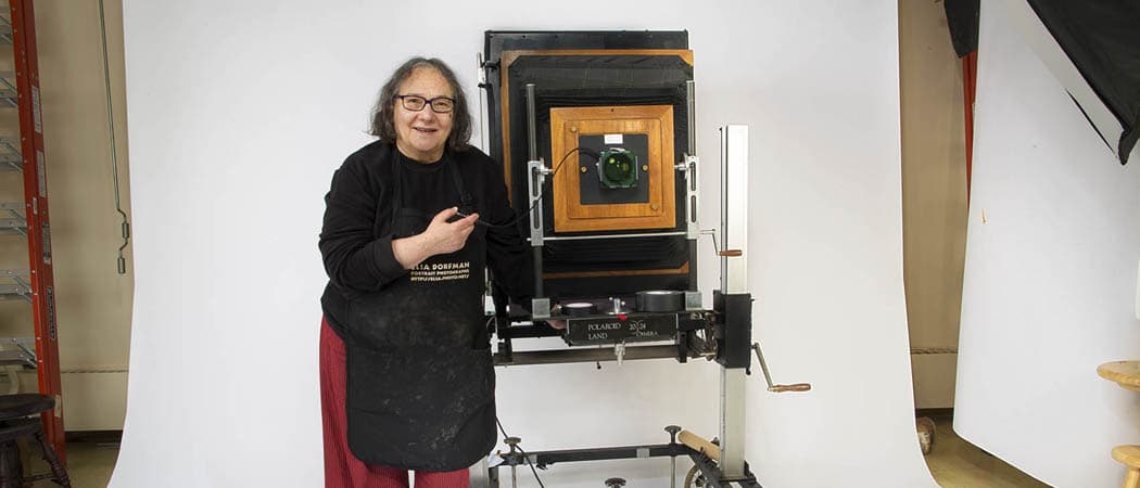 A fixture in Cambridge for decades and known for portraits often described as capturing the soul of her subjects, Esla Dorfman is taking her last shots. Here, Dorfman stands with her huge  20x24 Polaroid camera in her Cambridge studio. (Jesse Costa/WBUR)