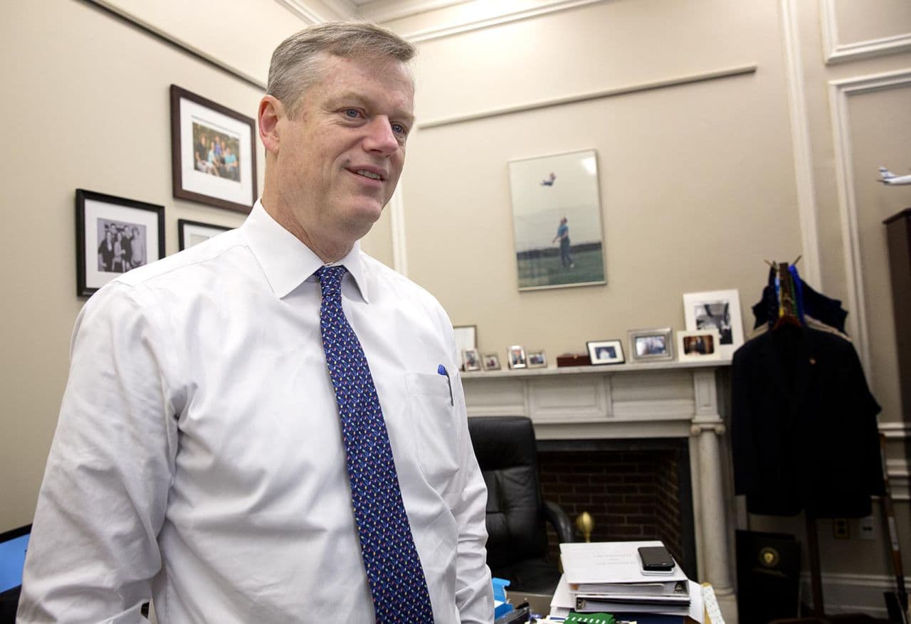 Gov. Charlie Baker, who's ending his first year as governor, is seen in his State House "working office" -- a space covered with family photos and personal memorabilia. (Robin Lubbock/WBUR)