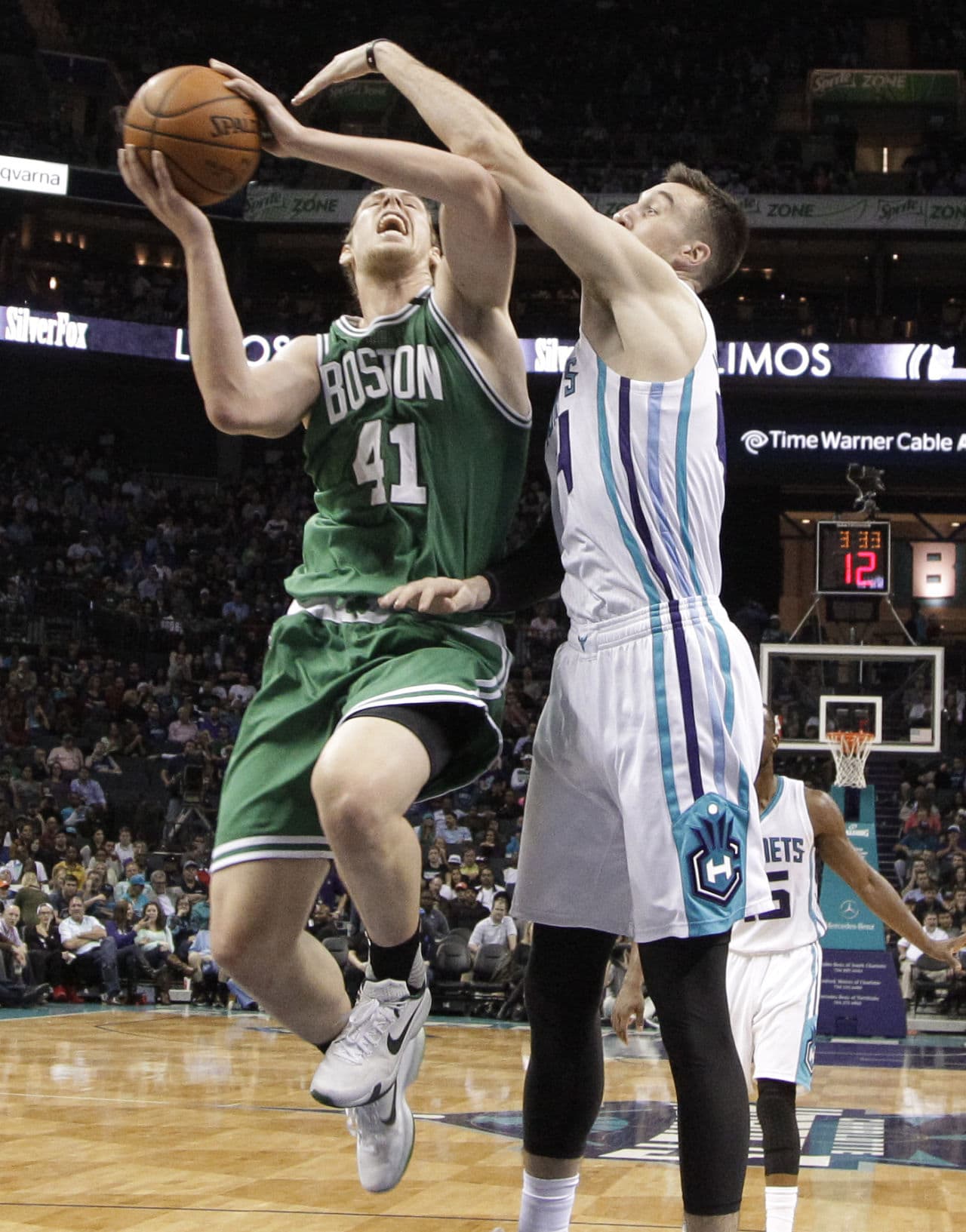 Boston Celtics' Kelly Olynyk (41) drives past Charlotte Hornets' Frank Kaminsky III (44) during the game. The Celtics won 102-89. (Chuck Burton/AP)