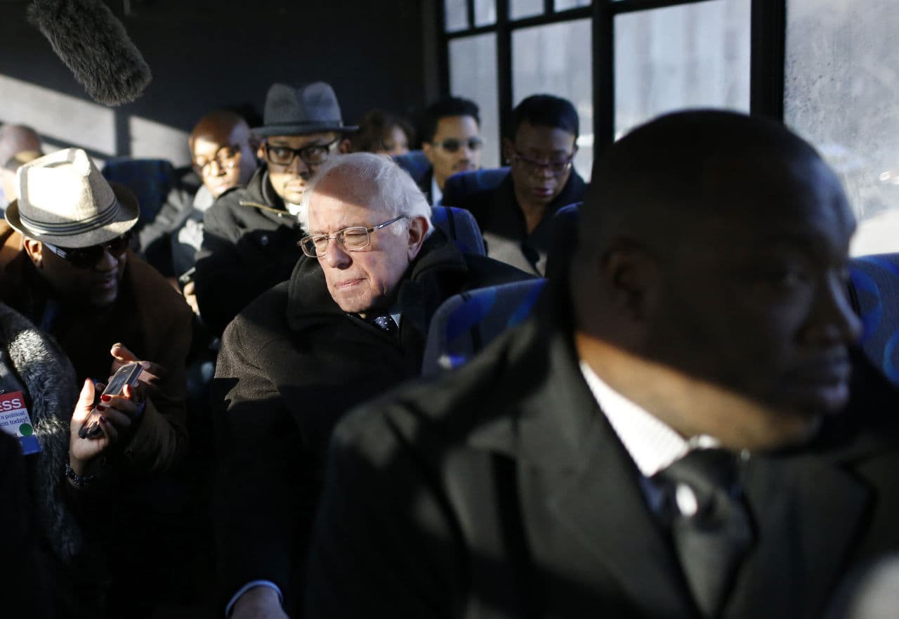 Democratic presidential candidate, Sen. Bernie Sanders, I-Vt., speaks with preachers and reporters aboard a bus as he tours the Sandtown-Winchester neighborhood of Baltimore, Tuesday, Dec. 8, 2015. Sanders toured areas where unrest folded following the funeral of Freddie Gray and met with African-American civic and religious leaders to discuss issues affecting the African-American community. (Patrick Semansky/ AP)