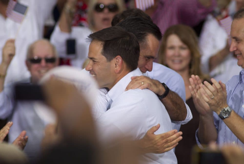 Marco Rubio hugs Mitt Romney during a campaign stop in Miami, in 2012, when Romney was running for president. Might Romney endorse Rubio for president now? (J Pat Carter/AP)