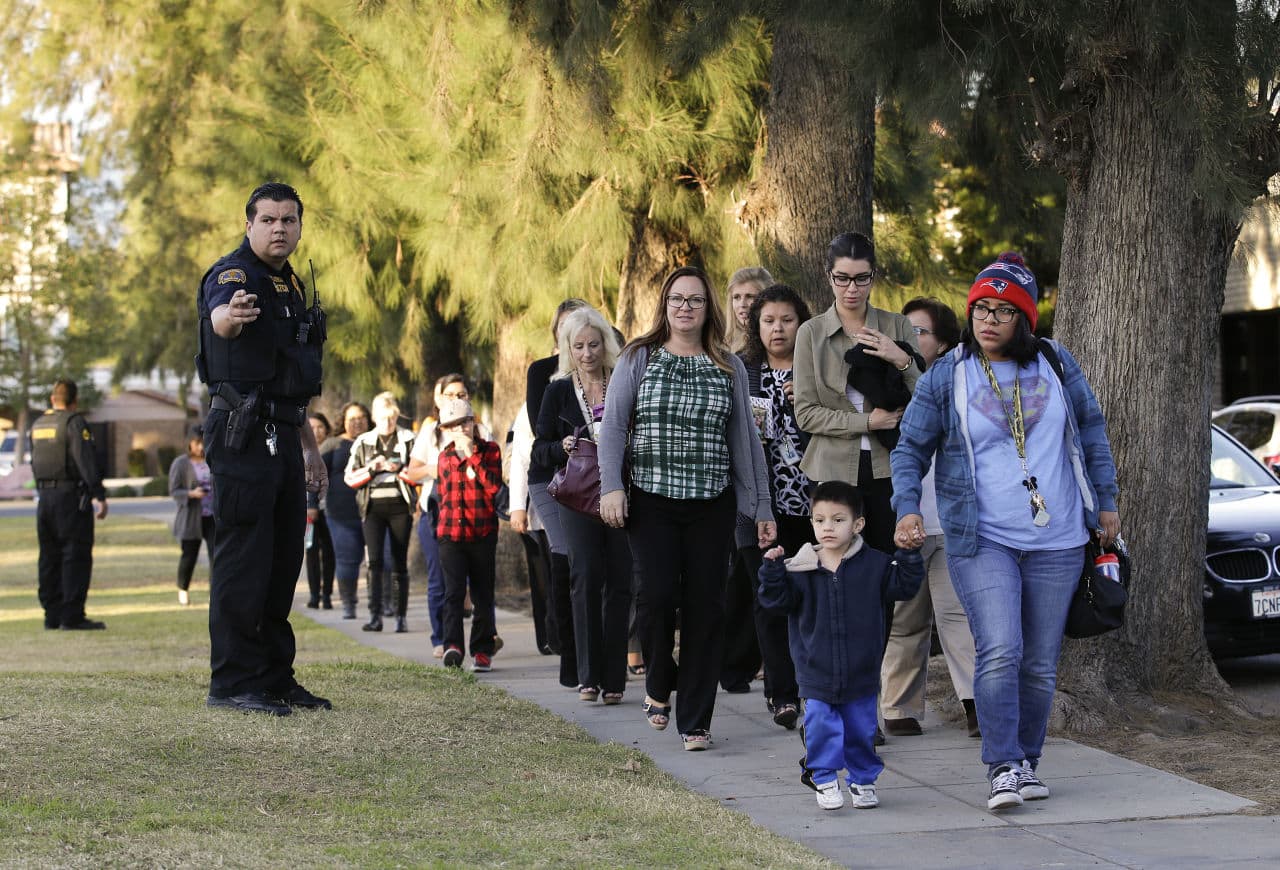 People who were near the shooting in San Bernardino that left at least 14 dead arrive at a community center to reunite with their family members. (Jae C. Hong/AP)