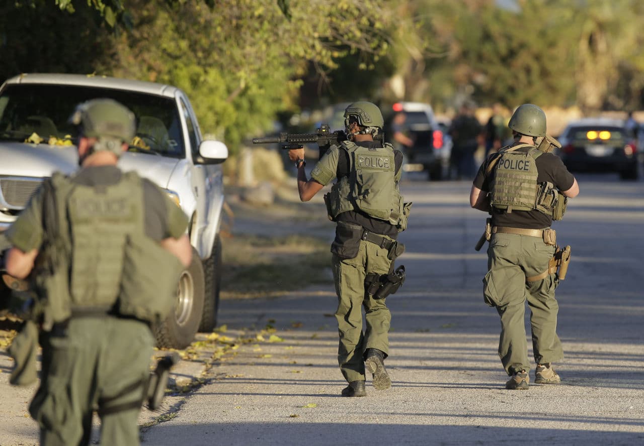 Law enforcement search for a suspect in Wednesday&#039;s shooting in California that left at least 14 dead. (Chris Carlson/AP)