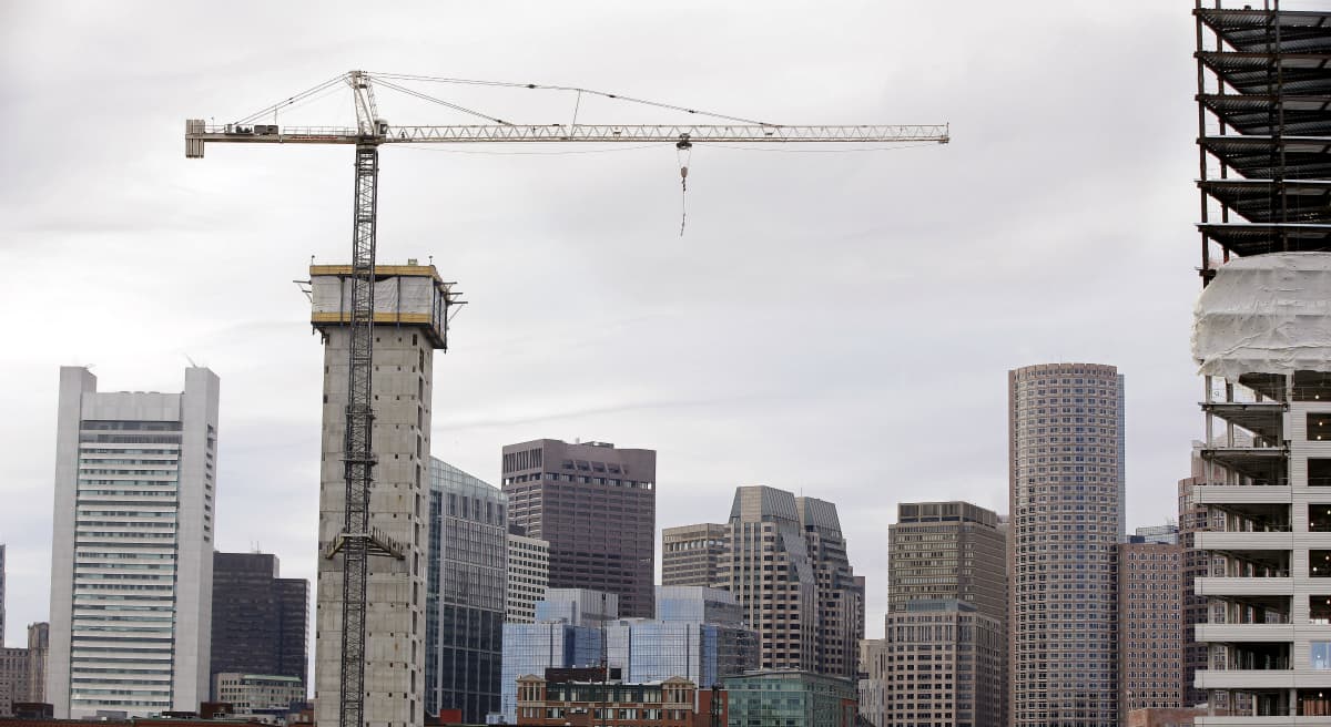 Mike Broida: "A city is only as vibrant as its population is diverse."
Pictured: Several commercial construction projects in the Seaport district of Boston as seen against the backdrop of the city's skyline. (Stephan Savoia/AP)