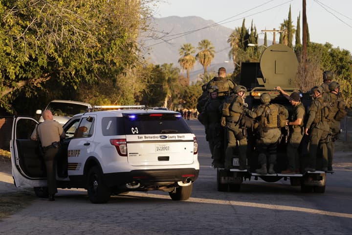 Law enforcement search for a suspect in a mass shooting that occurred at a Southern California social services center on Wednesday, Dec. 2, 2015, in San Bernardino, Calif. (AP Photo/Chris Carlson))