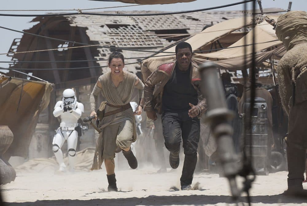 Rey and Finn run from stormtroopers and strafing First Order tie fighters. (Courtesy)