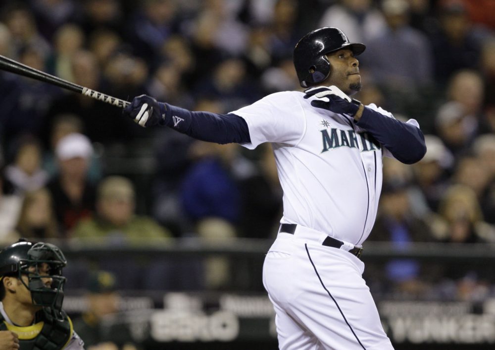 Seattle Mariners' Ken Griffey Jr. watches his three-run home run along with Oakland Athletics catcher Kurt Suzuki during the fifth inning of a baseball game Tuesday, Sept. 29, 2009, in Seattle. (Elaine Thompson/AP)