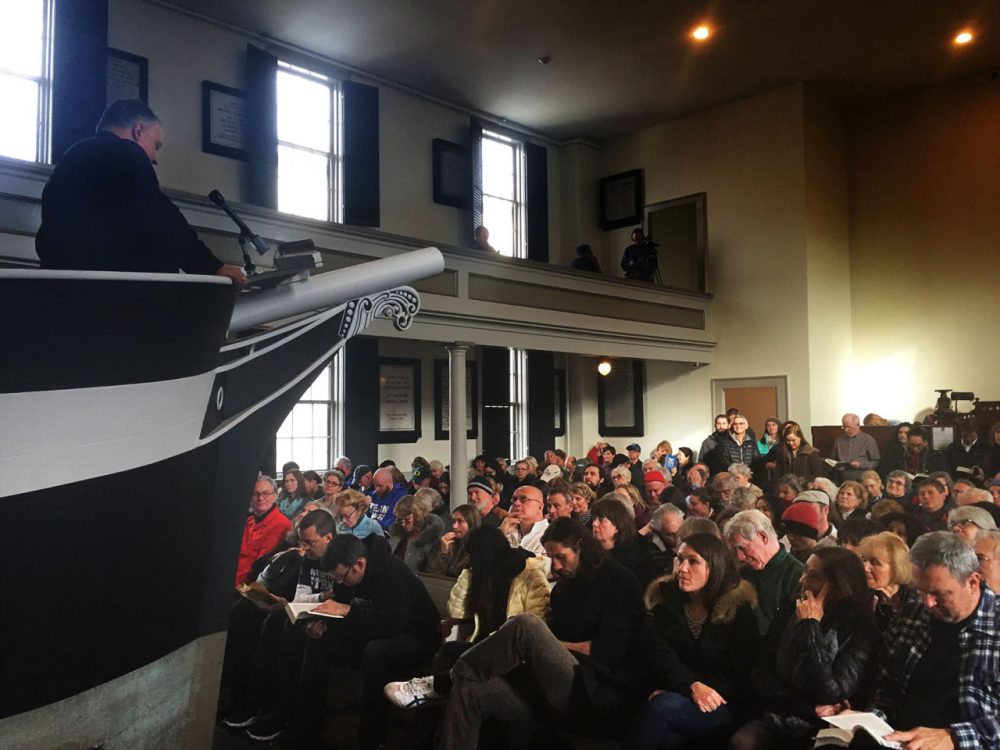 Participants in the 20th annual "Moby Dick Marathon" listen to the sermon of "Father Mapple" in the pews of Seamen’s Bethel. For his novel, Herman Melville took inspiration from an experience at the temple in New Bedford. (Simón Rios/WBUR)