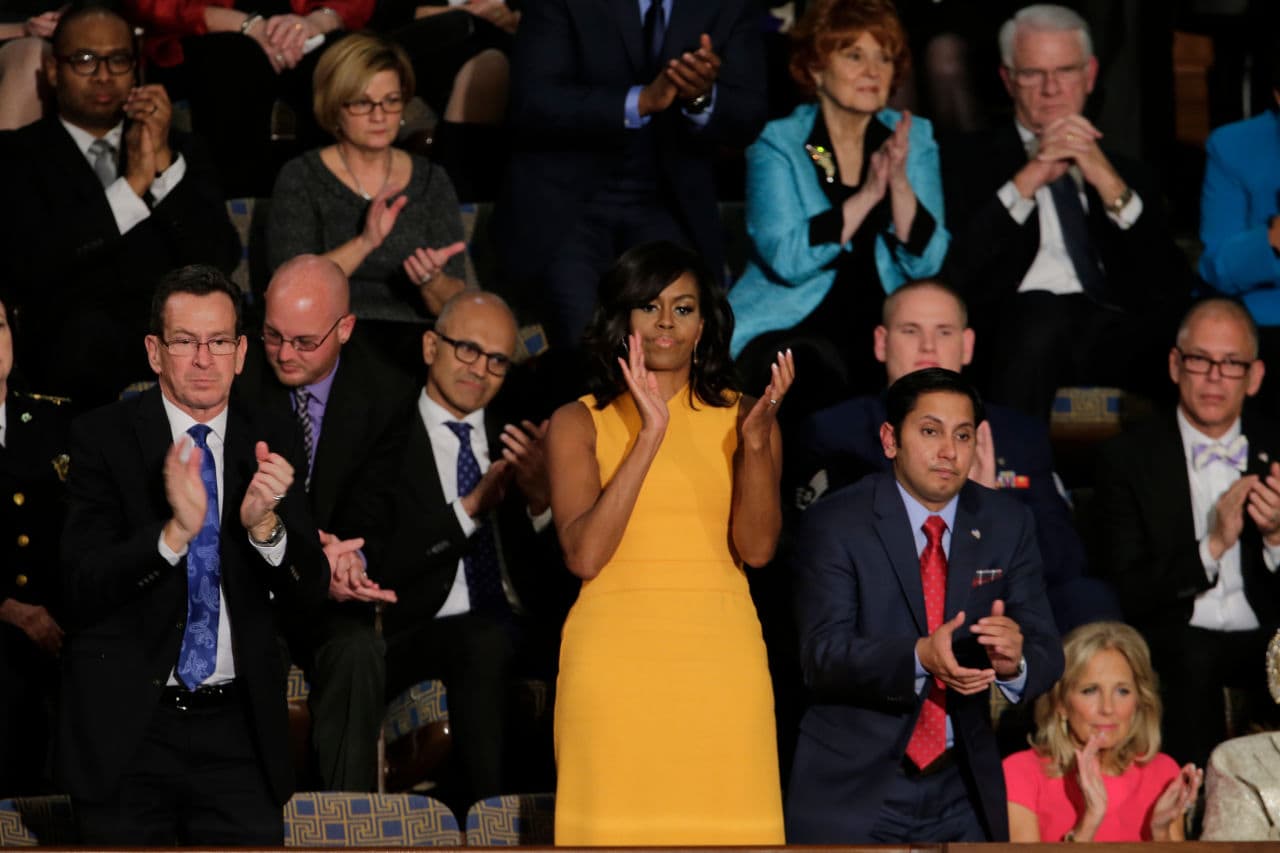 Michelle Obama applauds during President Obama's State of the Union address. Next to her a chair was left vacant to honor victims of gun violence. (J. Scott Applewhite/AP)