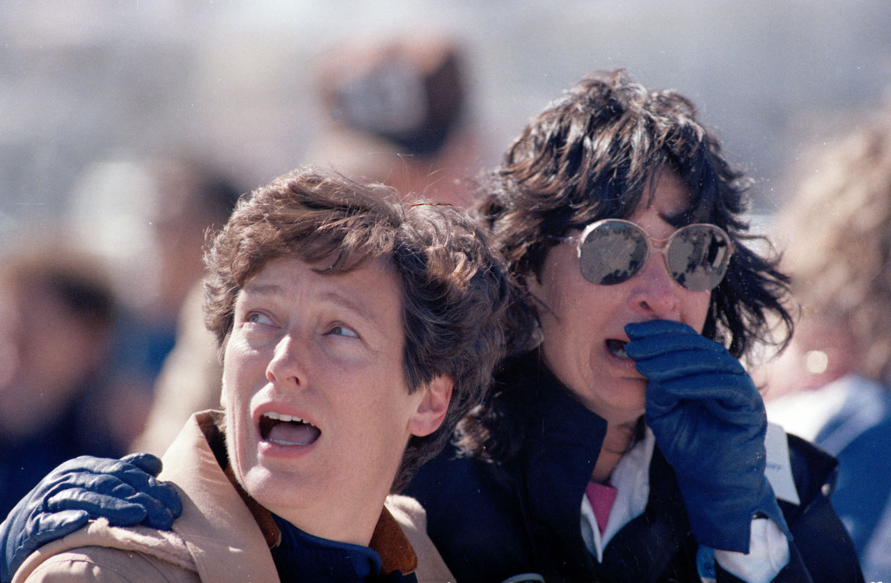 Two unidentified spectators react after witnessing the explosion of the Challenger. (AP)