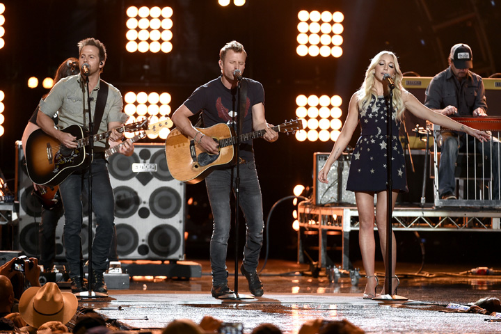 In this file photo, Kip Moore, from left, Dierks Bentley and Ashley Monroe perform at ACM Presents Superstar Duets at Globe Life Park on Friday, April 17, 2015, in Arlington, Texas. (Photo by Chris Pizzello/Invision/AP)