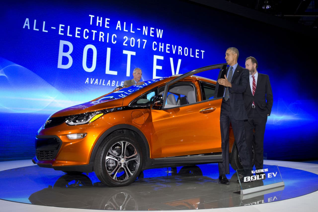 President Barack Obama steps from the new Chevrolet Bolt electric car as Dan Ammann, President, General Motors Company, stands right and Patrick Foley, controls manager for the Bolt EV at GM in Detroit, stands left, during a tour of the 2016 North American International Auto Show in Detroit, Wednesday, Jan. 20, 2016. (AP Photo/Carolyn Kaster)
