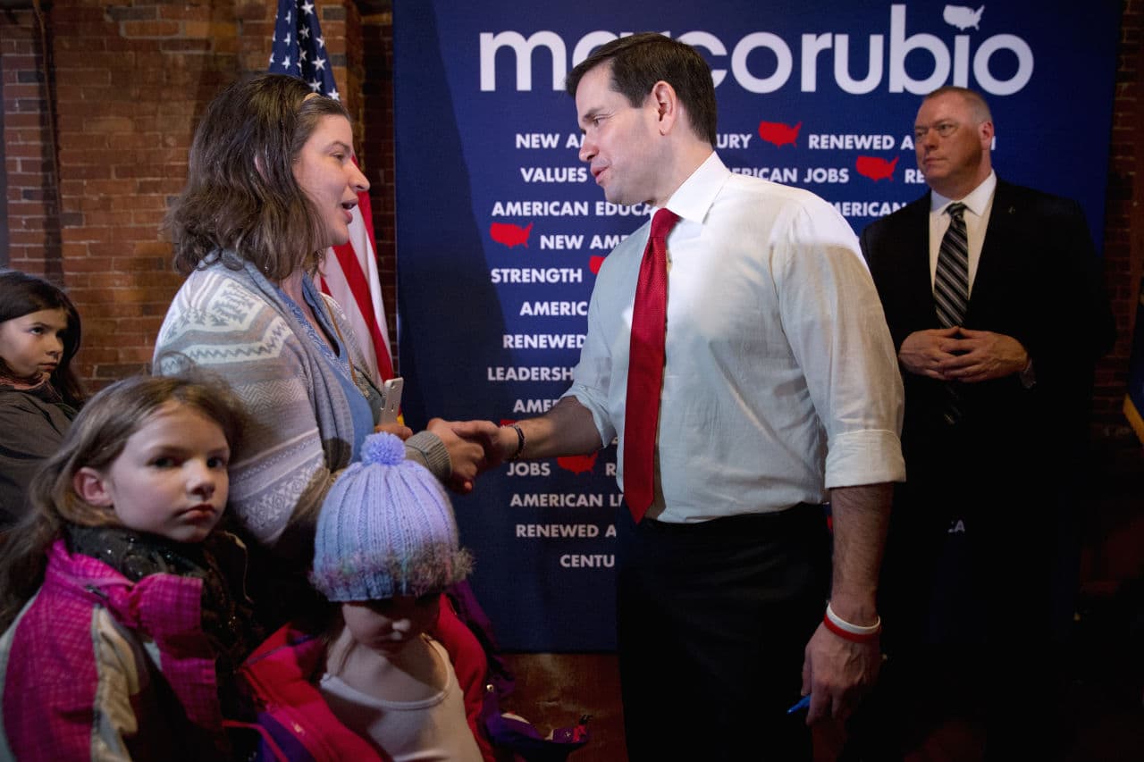 Surrounded by her three daughters, Svea, 9, left, Lydia, 7, and Elsa-Anne, 4, Melissa Mellor of Laconia, N.H., asks Republican presidential candidate, Sen. Marco Rubio, R-Fla. about his position on home-schooling after a town hall meeting in Laconia, N.H. on Wednesday. (Jacquelyn Martin/AP)