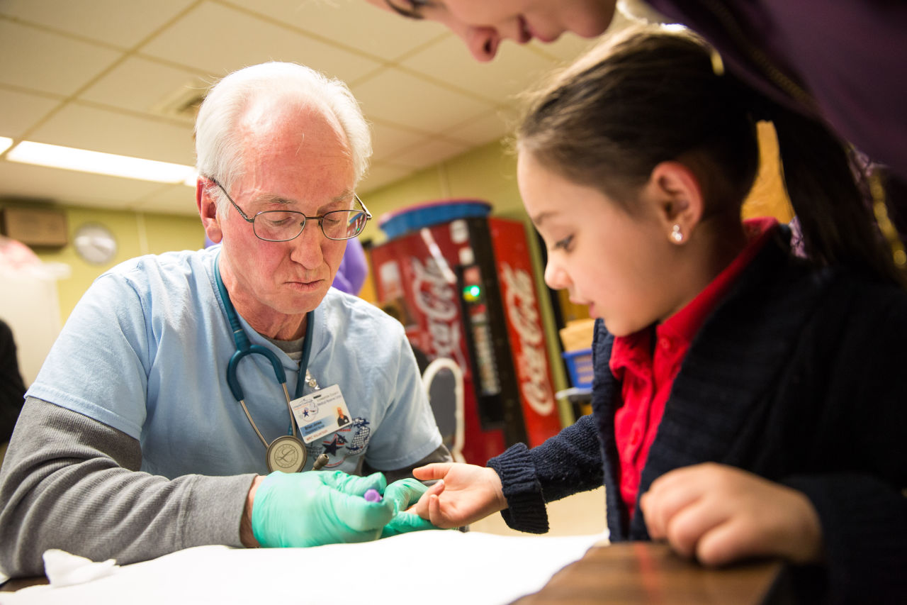 Brian Jones, a first responder for Livingston County Michigan, draws the blood of Amaria Roberson, age 5 of Flint, to screen her blood for lead on January 26, 2016 at Eisenhower Elementary School in Flint, Michigan. Free lead screenings are performed for Flint children 6 years old and younger, one of several events sponsored by Molina Healthcare following the city's water contamination and federal state of emergency. (Brett Carlsen/Getty Images)
