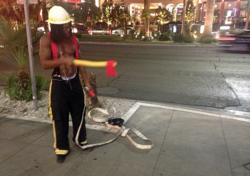 MJ Williams, 27, rents his "sexy firefighter" costume on the Las Vegas Strip for up to $9 an hour. He works solely for tips, and cannot afford health insurance. He supports Bernie Sanders. (Peter O'Dowd/Here & Now)