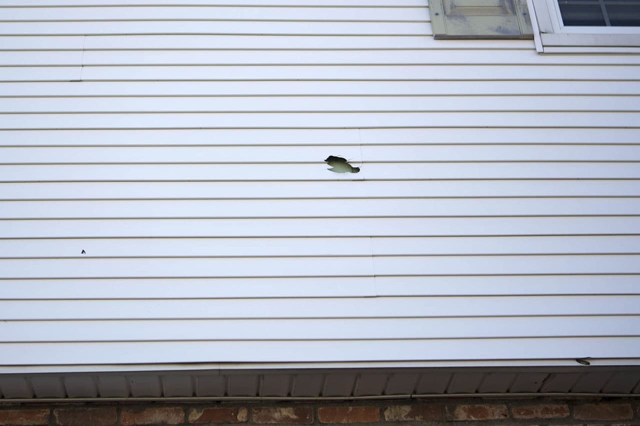 Three bullet holes remain on the exterior of Loretta Kehayias' home on Laurel Street in Watertown. (Jesse Costa/WBUR)