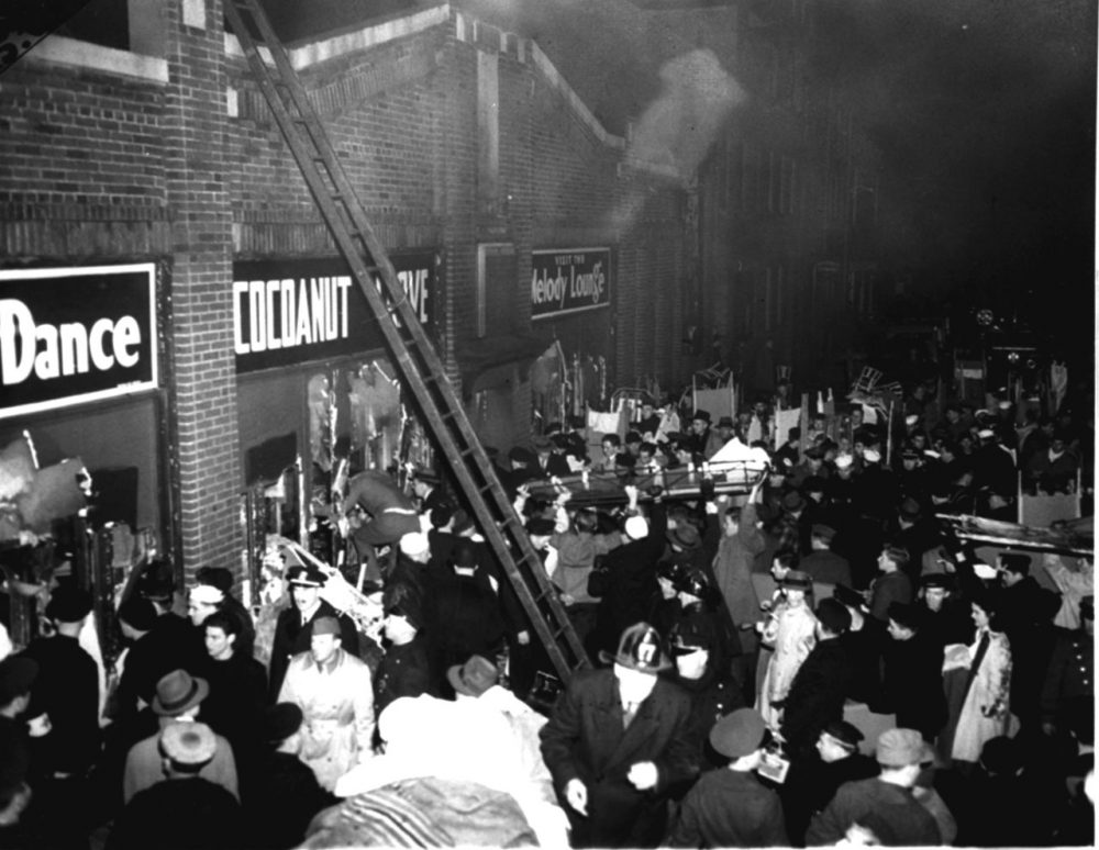 Boston fire and police department workers and many servicemen jam the street outside the Cocoanut Grove nightclub on November 28, 1942. (AP Photo)