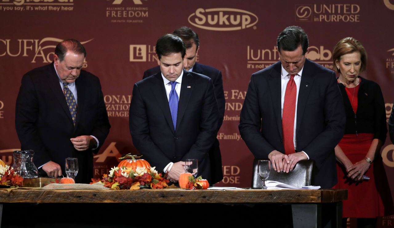 Republican presidential candidates, from left, former Arkansas Gov. Mike Huckabee, Sen. Marco Rubio, R-Fla., former Pennsylvania Sen. Rick Santorum and Carly Fiorina bow their heads in prayer at the end of the Presidential Family Forum, Friday, Nov. 20, 2015, in Des Moines, Iowa. (Charlie Neibergall/ AP)