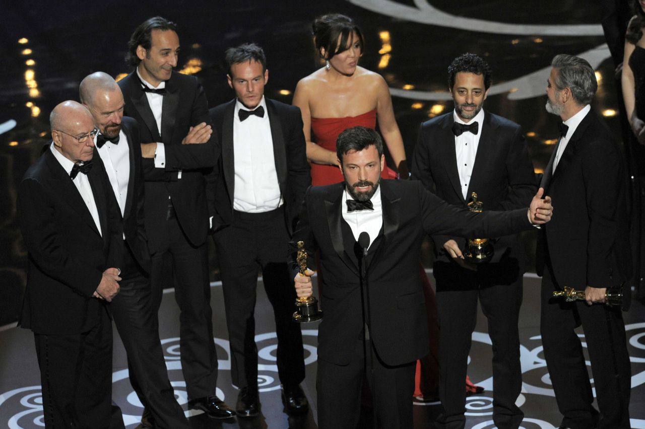 Director/producer Ben Affleck, center, accepts the award for best picture for "Argo," as the cast and crew look on at the 2013 Oscars. (Chris Pizzello/Invision/AP)