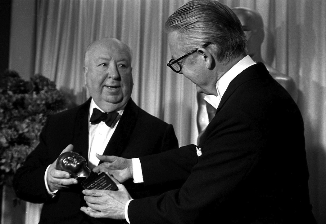 Alfred Hitchcock winning the Irving Thalberg Award at the 1968 Oscars from Robert Wise. He never won a best director award. (AP)