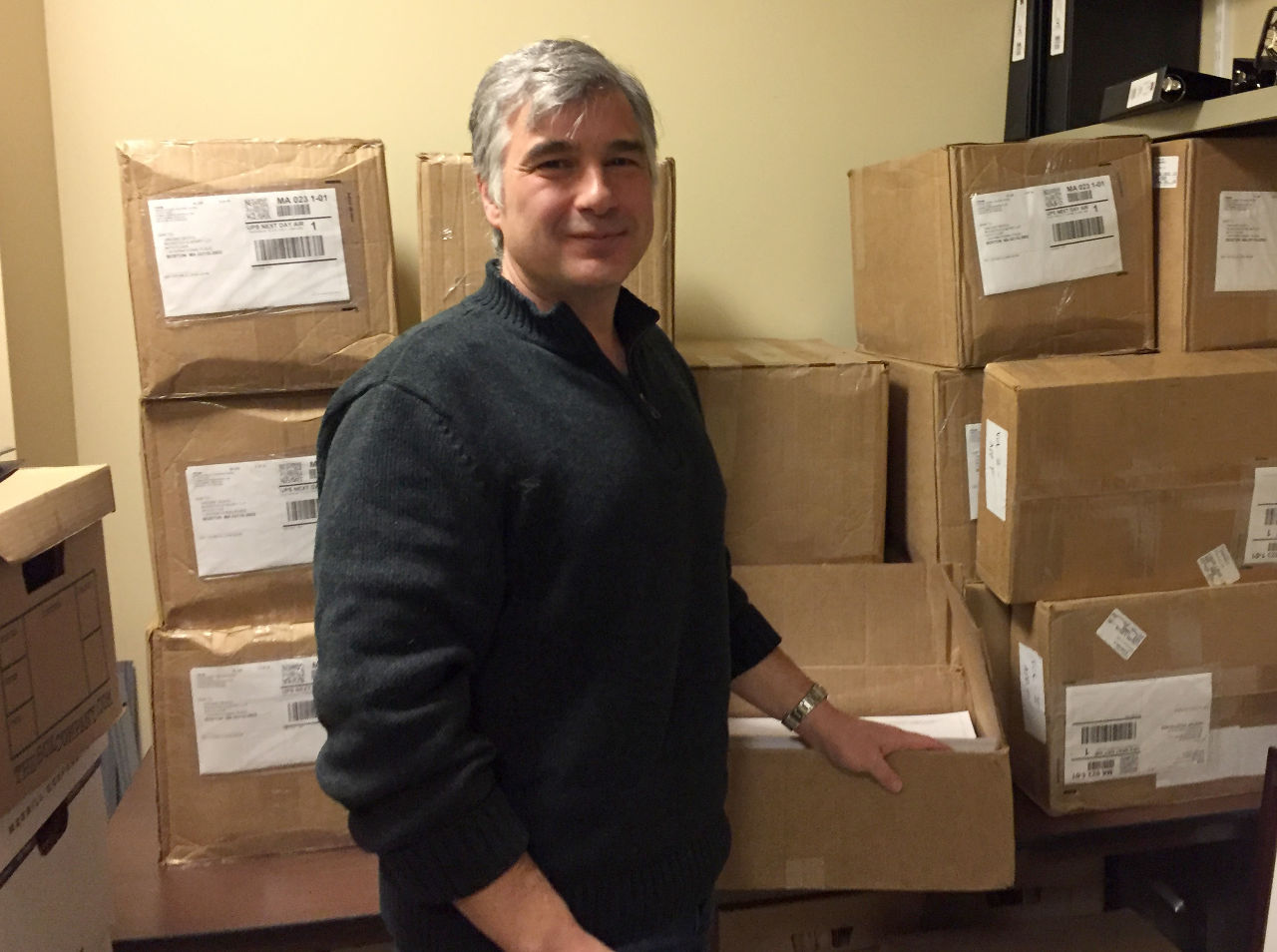 Attorney Vincent DeVito represents Northeast Energy Solutions, a coalition of environmental and land trusts in the region opposed to the Kinder Morgan pipeline. Here, DeVito is seen in his "war room” -- a storage closet filled with boxes containing documents Kinder Morgan filed with the U.S. government seeking permission to build its pipeline. (Bruce Gellerman/WBUR)