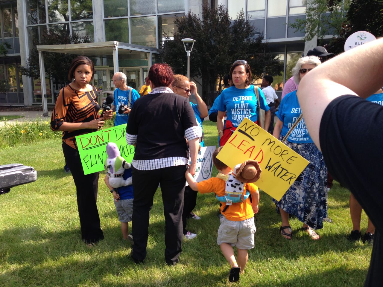 A Flint resident and her son are pictured at the Detroit to Flint Water Justice Journey rally in Flint, Michigan, July 10, 2015. (Courtesy of the author)