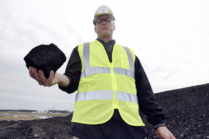 In this Oct. 21, 2013, file photo, Vern Lund, president of Liberty Mine in central Mississippi near DeKalb, Miss., holds some of the lignite coal planned for use in the nearby Mississippi Power Co. carbon capture power plant. (AP Photo/Rogelio V. Solis, File)