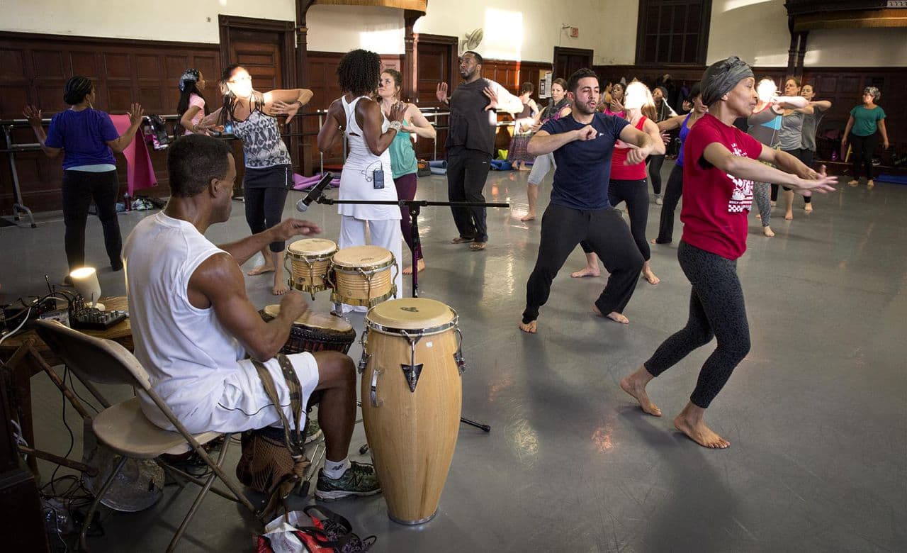 Afro Flow Yoga instrumentalist Jeff W. Jones, plays the drums for the dance section of a workout. (Robin Lubbock/WBUR)