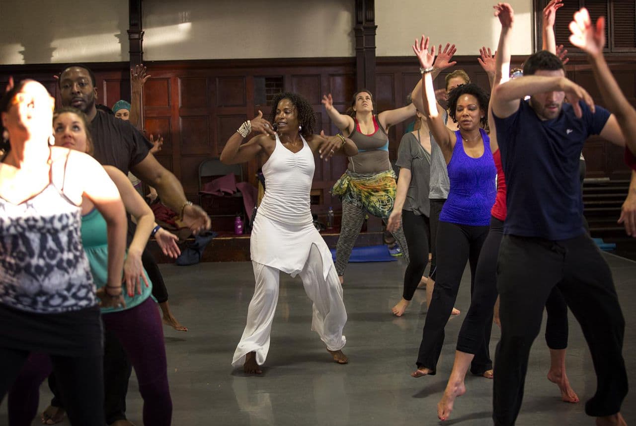 Leslie Salmon Jones leads the group in a more active part of a yoga session. (Robin Lubbock/WBUR)
