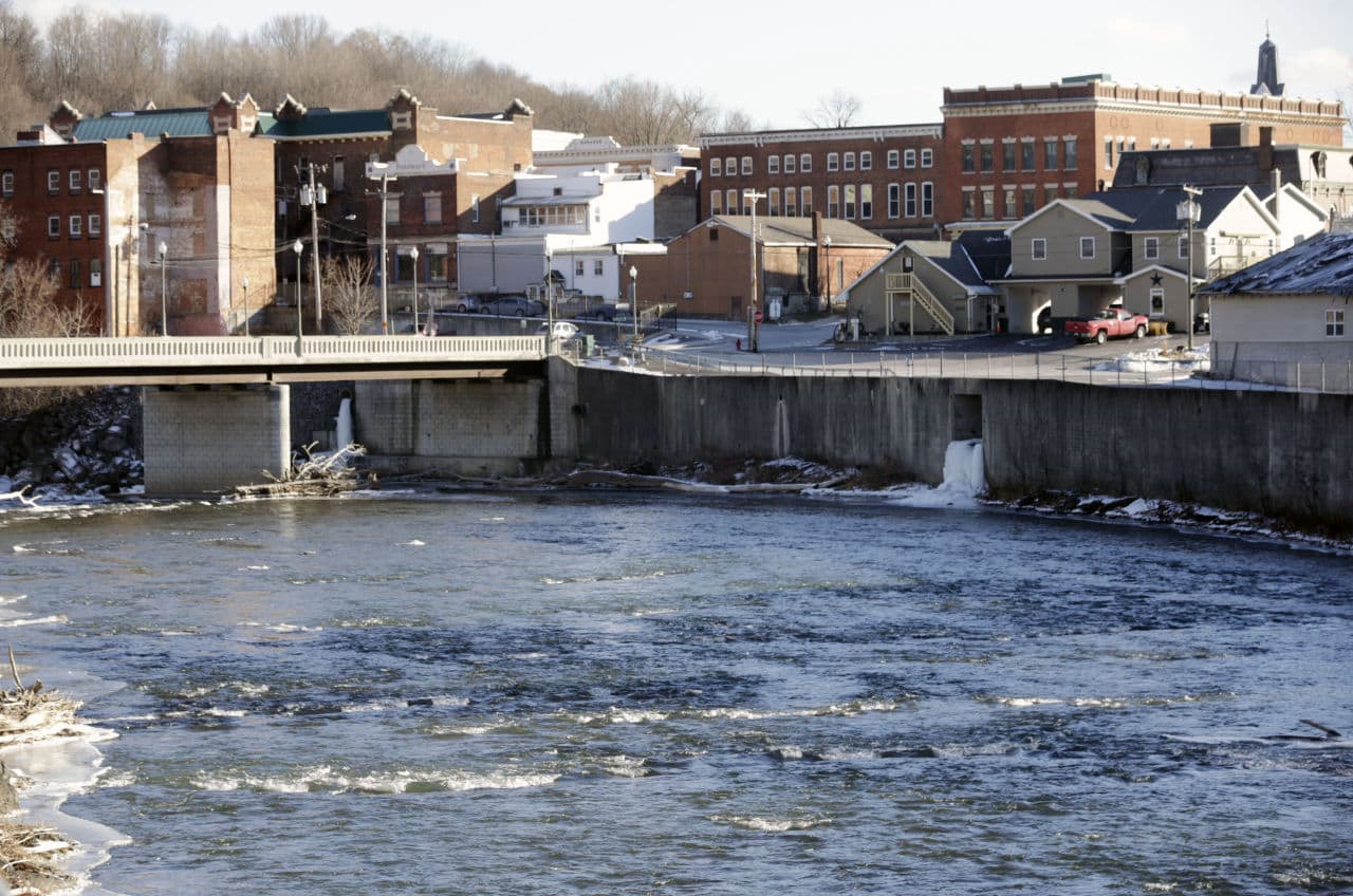 In this Jan. 21, 2016, photo, the Hoosic River runs through the village of Hoosick Falls, N.Y. New York regulators say Saint-Gobain Performance Plastics and Honeywell International are required to pay for the investigation and cleanup of a toxic chemical in the upstate villages drinking water. (Mike Groll/AP)