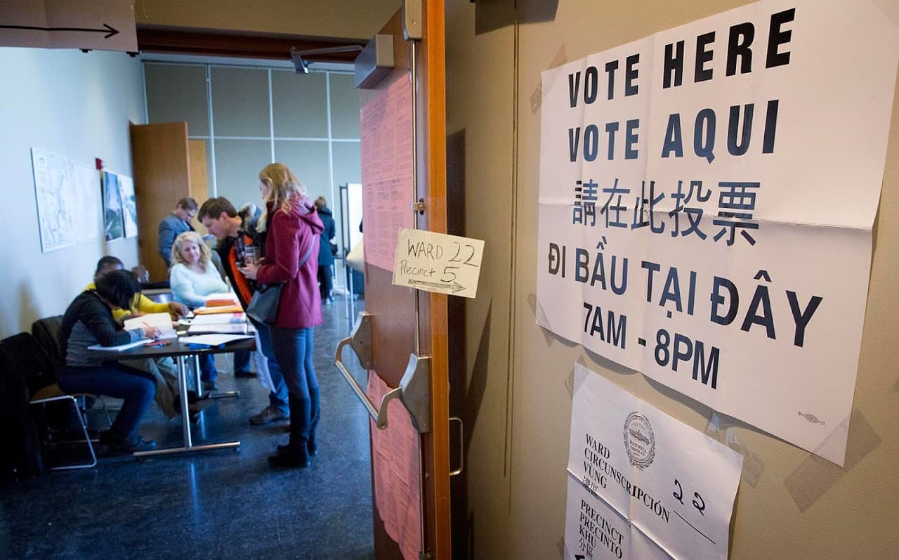 Voters check in at the polling station at the Honan-Allston Branch of the Boston Public Library. (Robin Lubbock/WBUR)