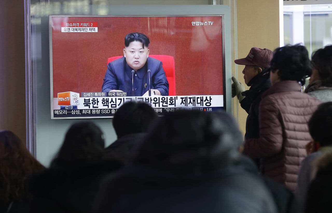People watch a TV news program showing North Korean leader Kim Jong Un, at Seoul Railway Station in Seoul, South Korea, Thursday, March 3, 2016. North Korea fired several short-range projectiles into the sea off its east coast Thursday, Seoul officials said, just hours after the U.N. Security Council approved the toughest sanctions on Pyongyang in two decades for its recent nuclear test and long-range rocket launch. The screen reads "Sanction on the North Korea." (Ahn Young-joon/AP)